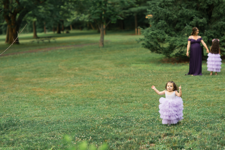 I was thrilled when Michelle from Pink Comb Studio reached out for her maternity photos. Following COVID-19 rule, keeping social distance I photographed Michelle and her two beautiful girls at Watchung Mountain NJ. With overcast weather three trees and grass showed such a rich deep green colors. I love bold rich colors in my photos as much as I love sunset golden hour. Michelle was just glowing and looked so beautiful. Was so happy to have such a beautiful mama in front of my camera before Michelle becomes mama of three girls. I can not wait to see her new baby girl and see her family grow. Michelle Surgent’s maternity session captured by Karis from heykaris.